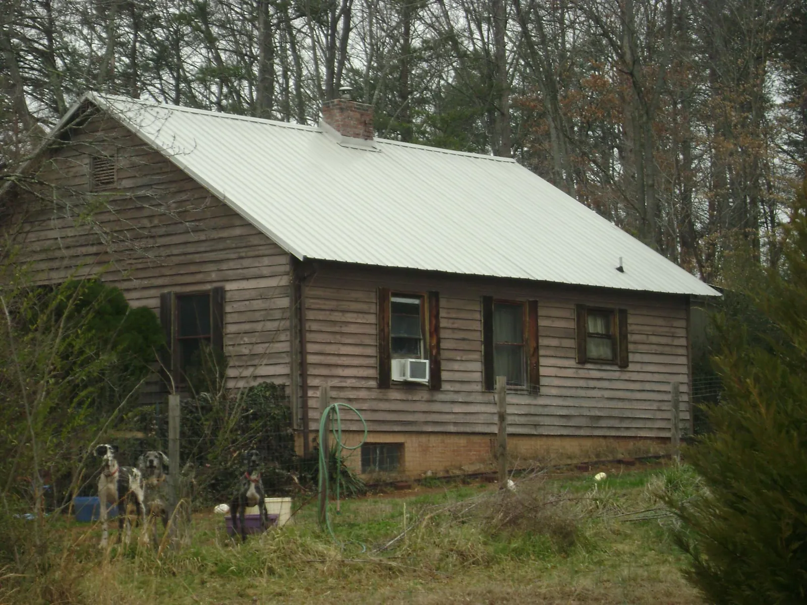 White metal roof on an old wood sided farmhouse, from a Metal Roof Installation job in Woodbine